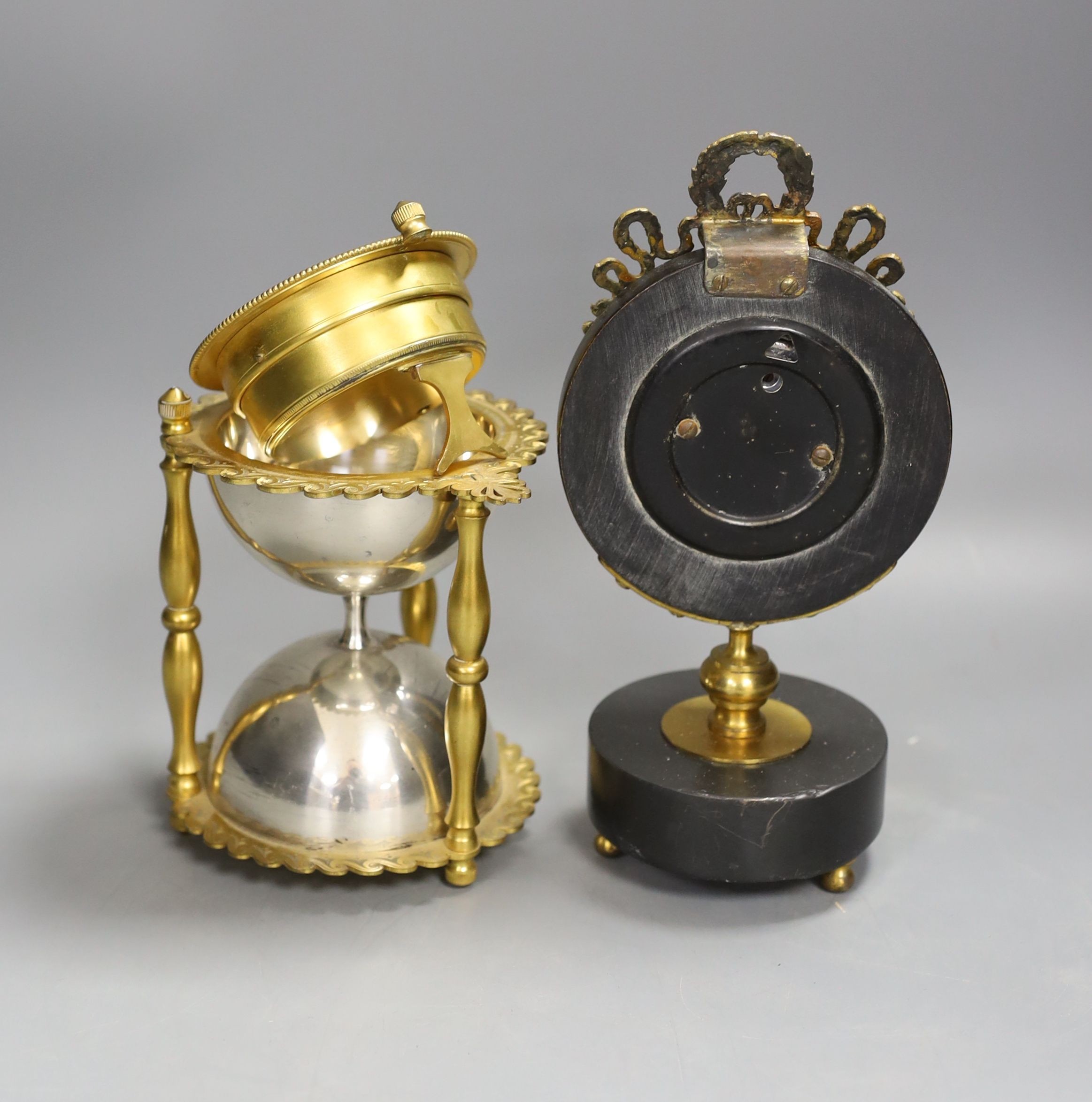 An ormolu and silver plated hourglass shaped desk aneroid barometer and a gilt metal and parcel ebonised desk barometer